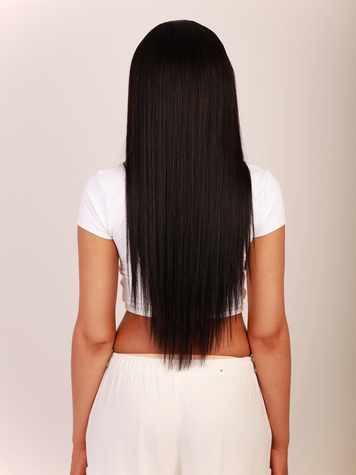 Rear view of Yaki straight hair extensions, showing a smooth, seamless blend with type 4 hair