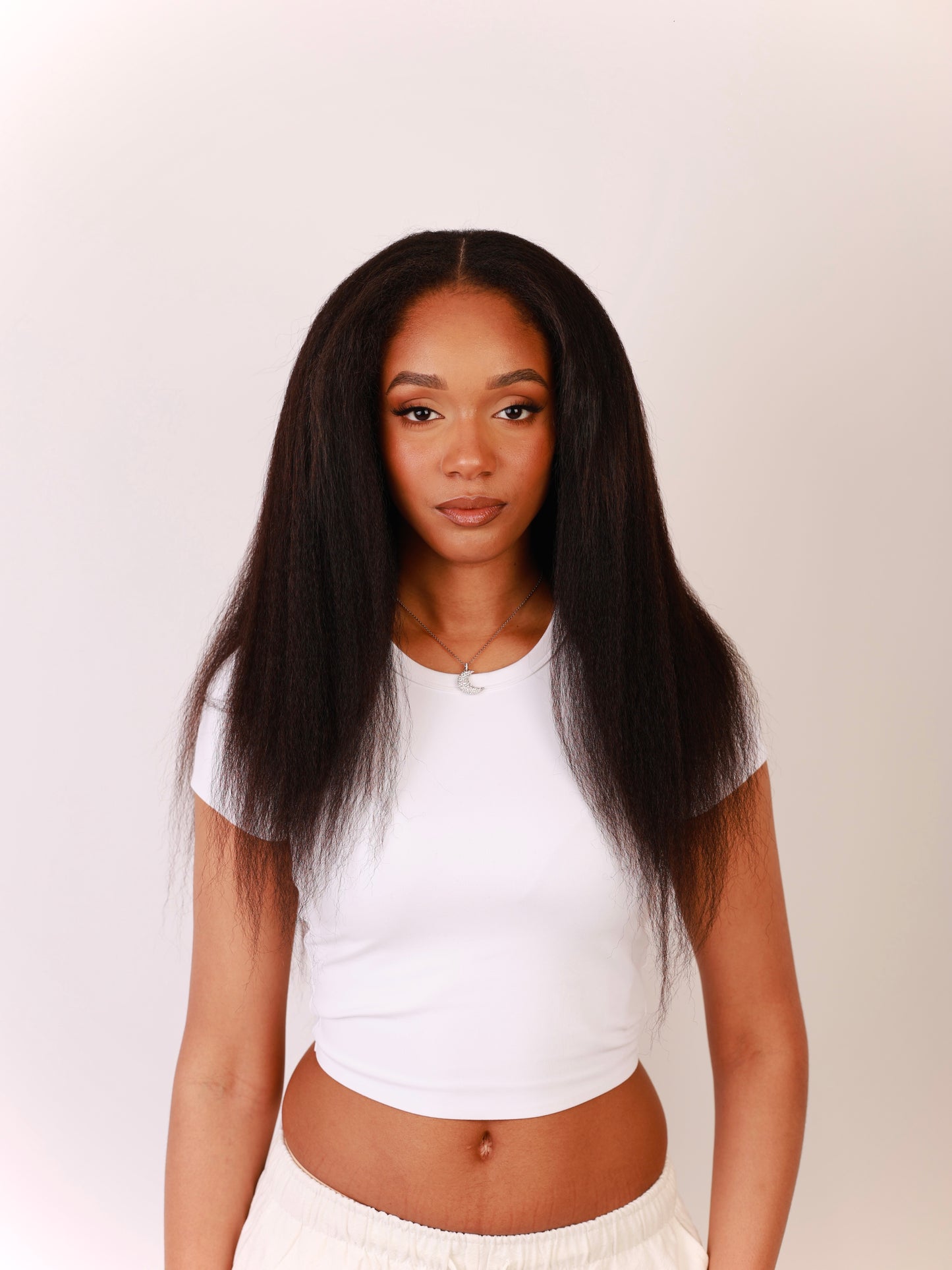 Front view of model wearing 20 inch kinky straight hair extensions