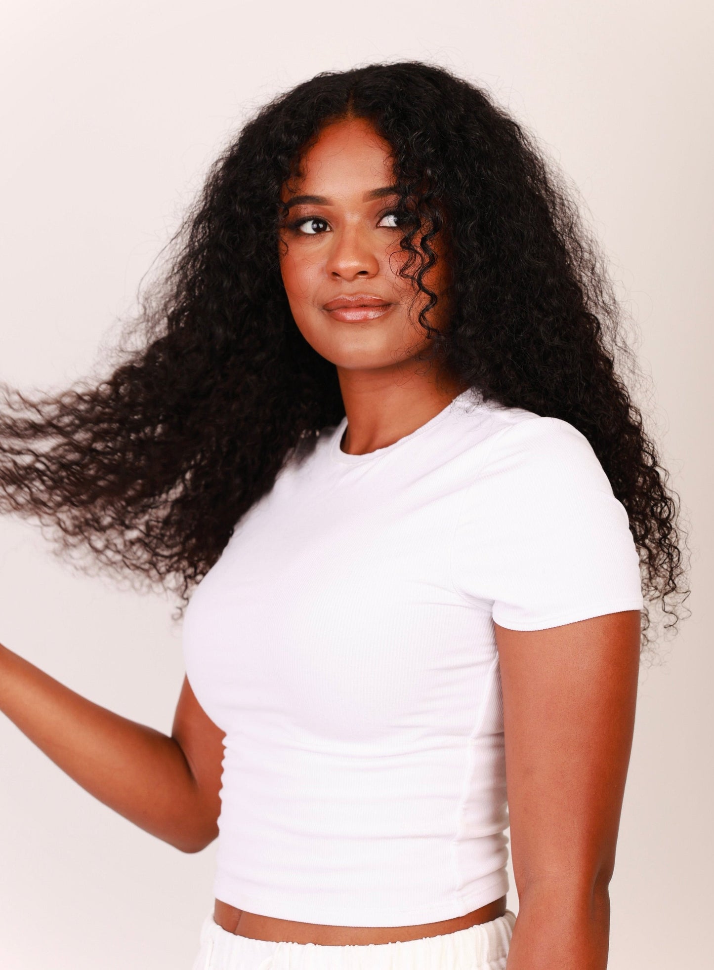 Front view of model wearing 20 inches of deep curly hair extensions